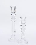 Two clear glass candlesticks of different sizes on a white background, designed in a simple and elegant style.