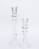 Two clear glass candlesticks of different sizes on a white background, designed in a simple and elegant style.