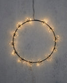 Circular string light decoration on a textured wall