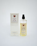 A bottle of Jean d'Aigle Eau de Cologne Elixir next to its white packaging box, set against a plain light gray background.