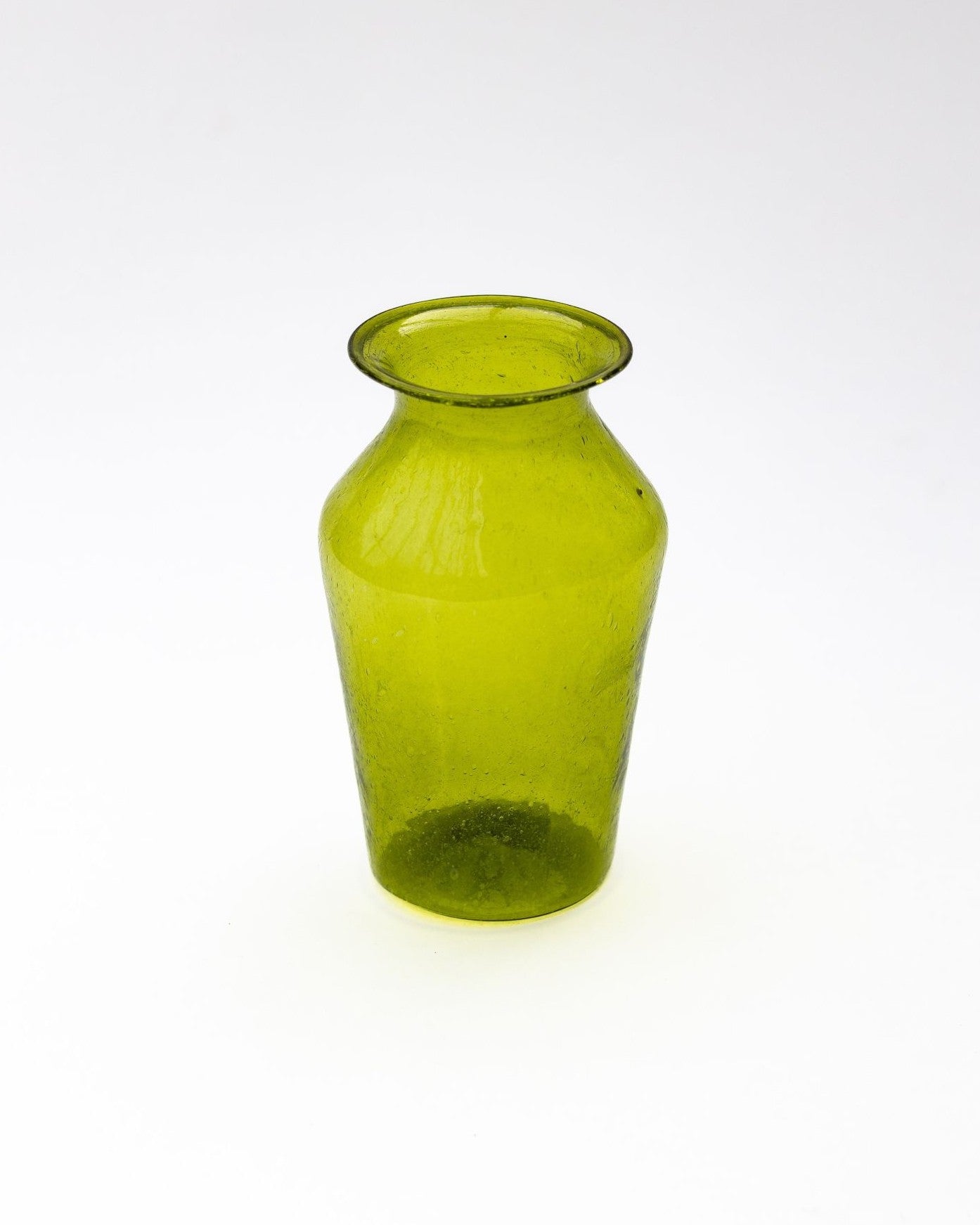 Green glass vase on a white background