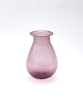 Pink glass vase on a white background