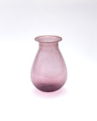 Pink glass vase on a white background